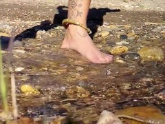 Walking barefoot in the river. Hairy legs. Ankles jewelery.