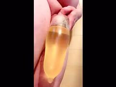 Tiny Tgirl dick fills condom with golden piss