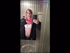 Femboy undresses in a public restroom.