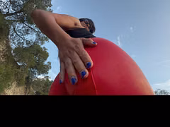 Red latex spanking outdoors